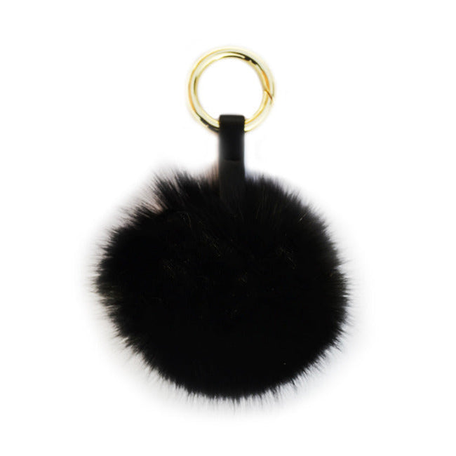 Svart fluffig päls boll