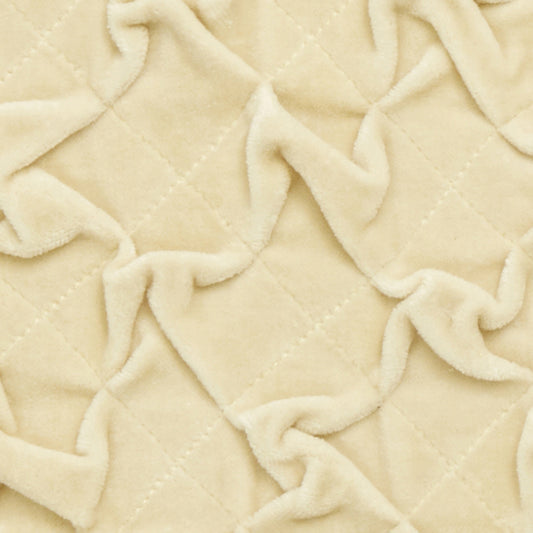 Detalj av beige sammetskudde