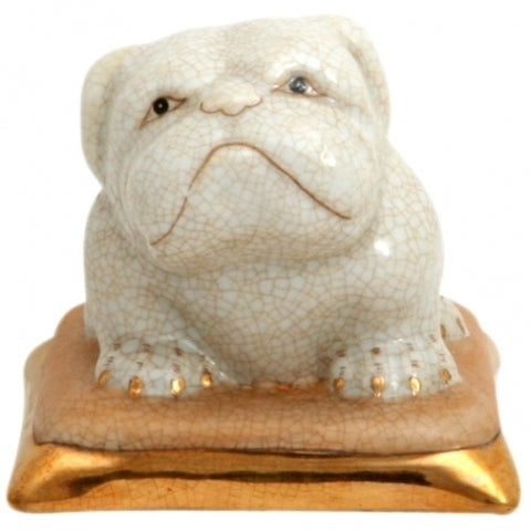 Bulldogg på gyllene kudde i porslin